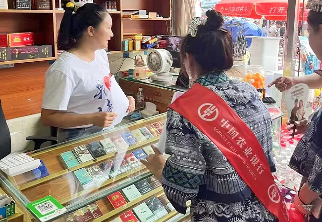 (图为:农业银行榕江县支行工作人员主动上门为商家提供金融服务).jpg