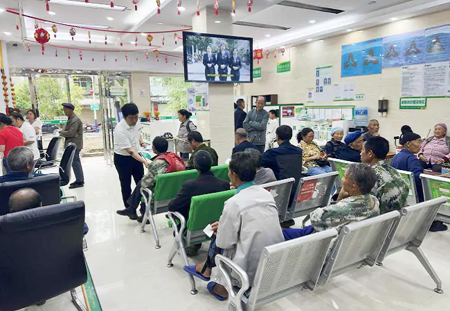 （图为：客户经理向客户发放金融知识普及宣传折页 ）.png