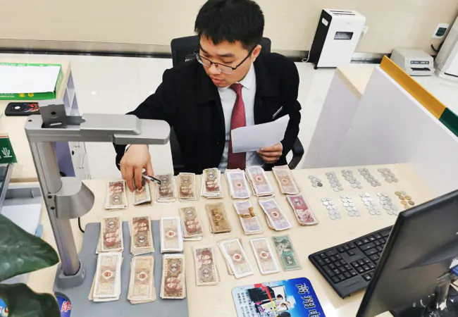 （图为：排调支行工作人员耐心整理清点破钞零钞）.png